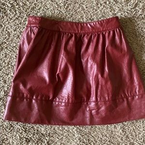 Maroon leather skirt.
